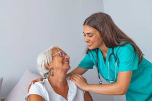 Older adult and family member reviewing a daily support plan at a kitchen table.